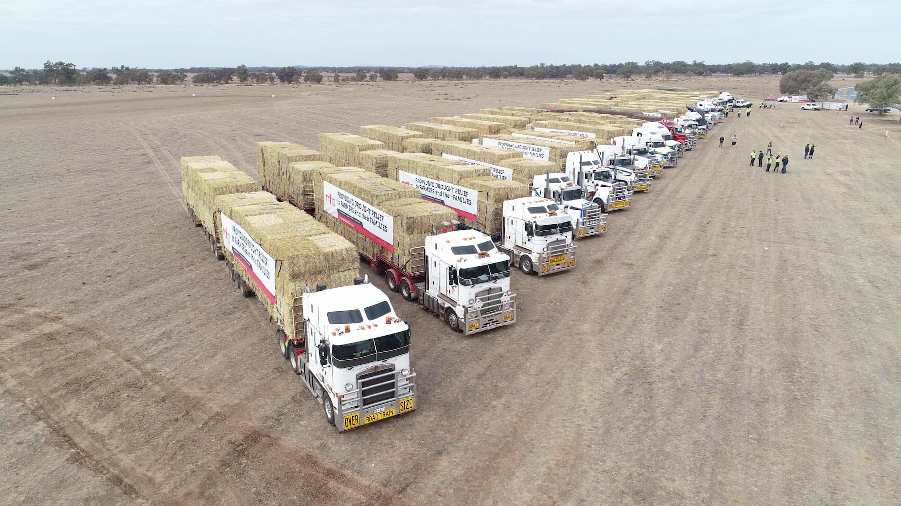 Drought Relief - Rapid Relief Team RRT Supporting Australians through hard times.  Trucks lined up donating hay bales 